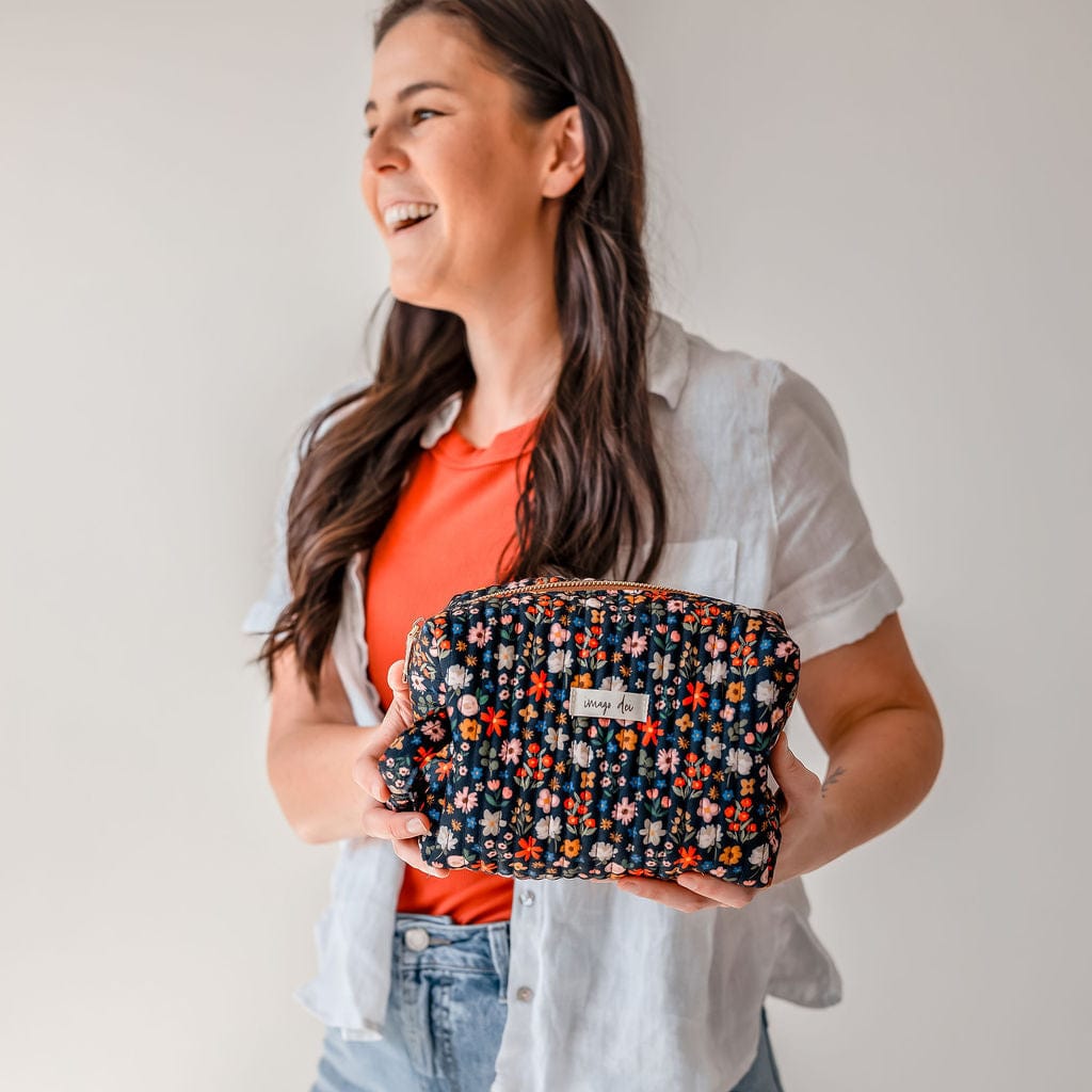 Woman holding a floral print bag.