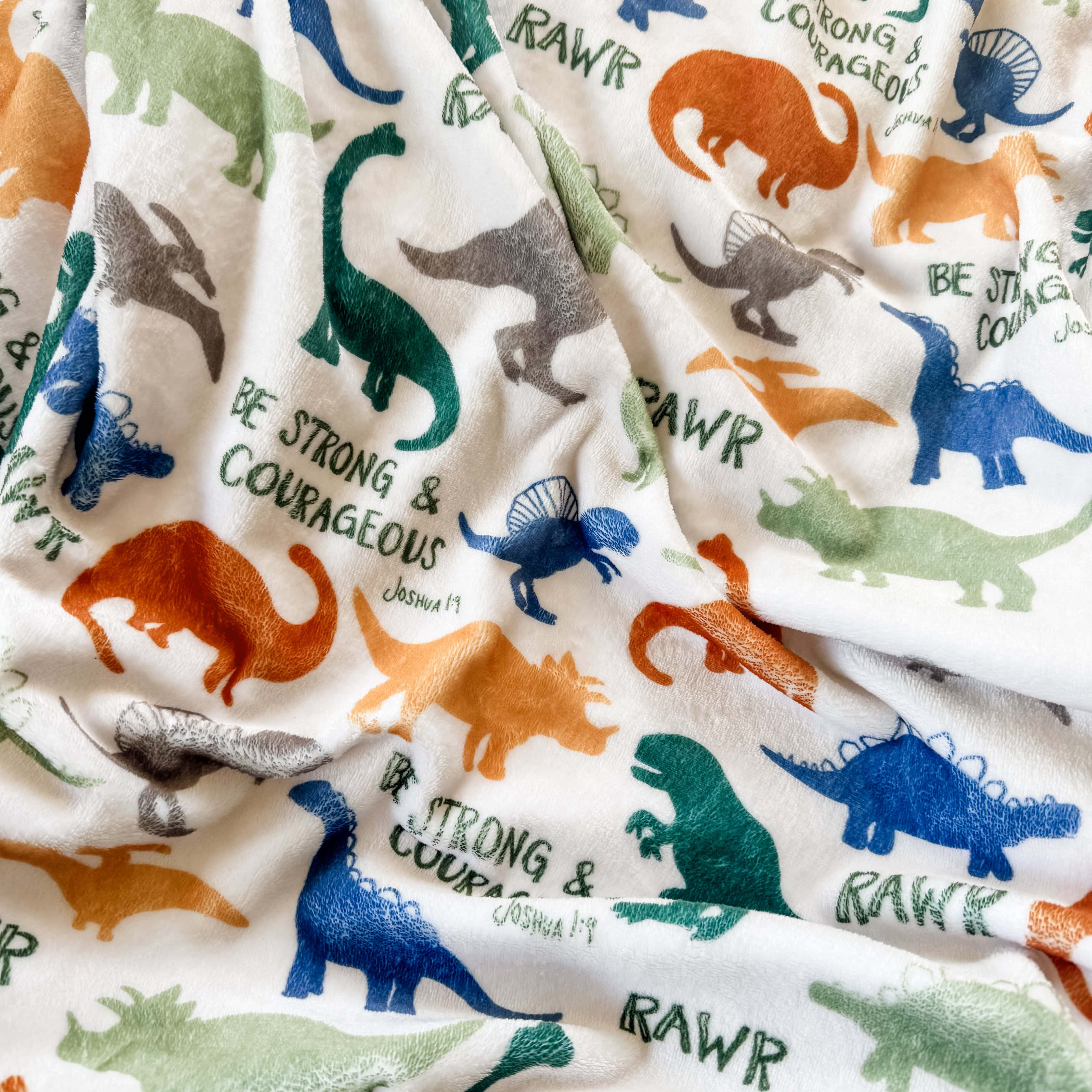 Dinosaur blanket with Be Strong & Courageous text