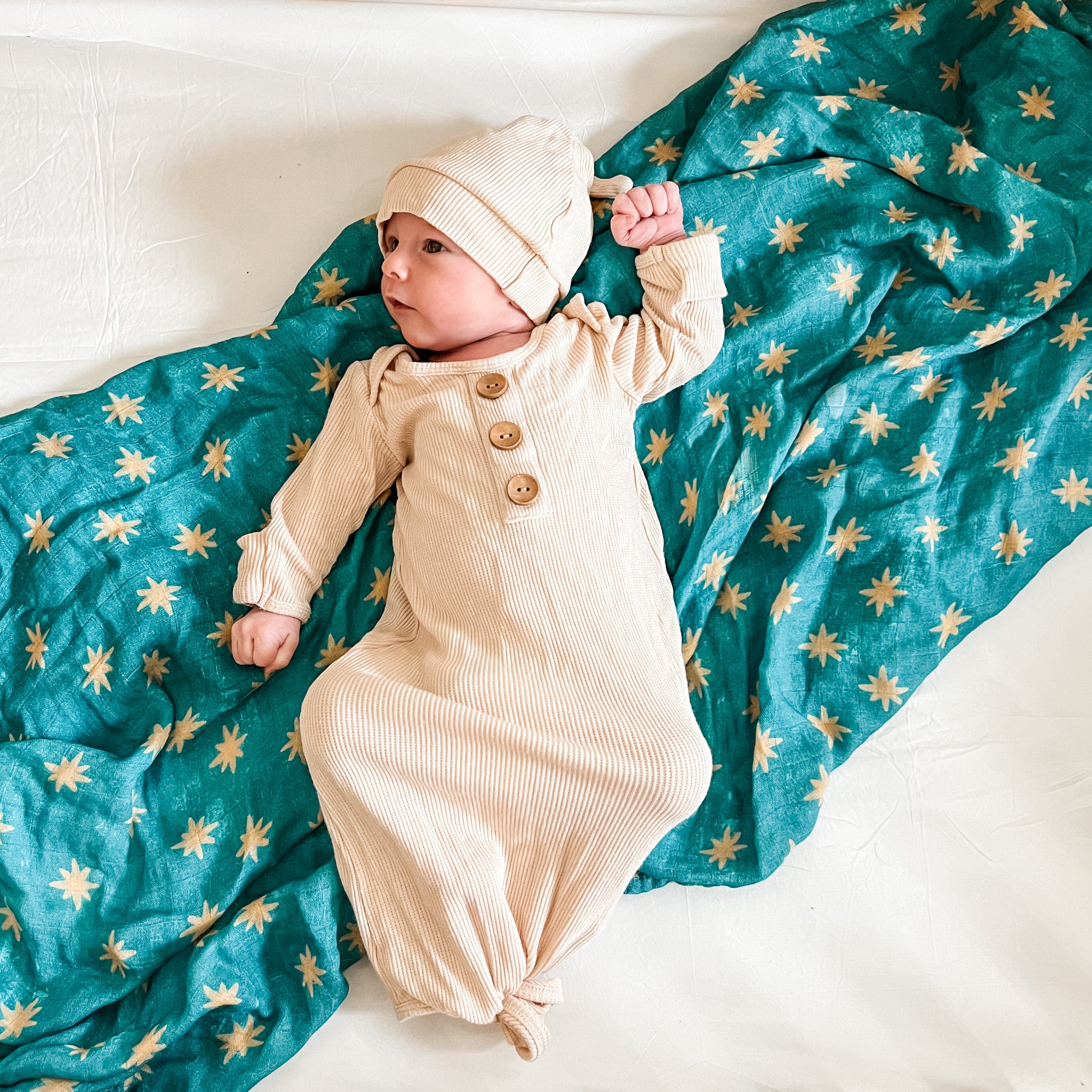 Baby in Guadalupe swaddle and hat