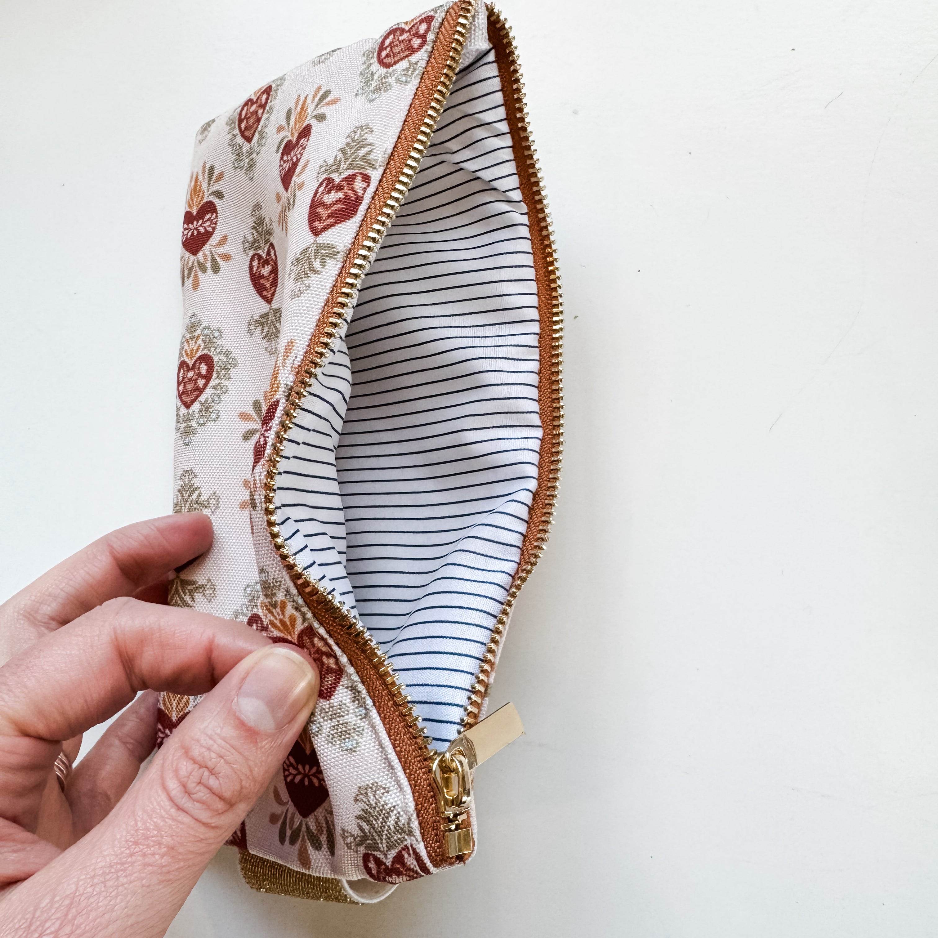 HFH pouch with hearts, open showing striped lining