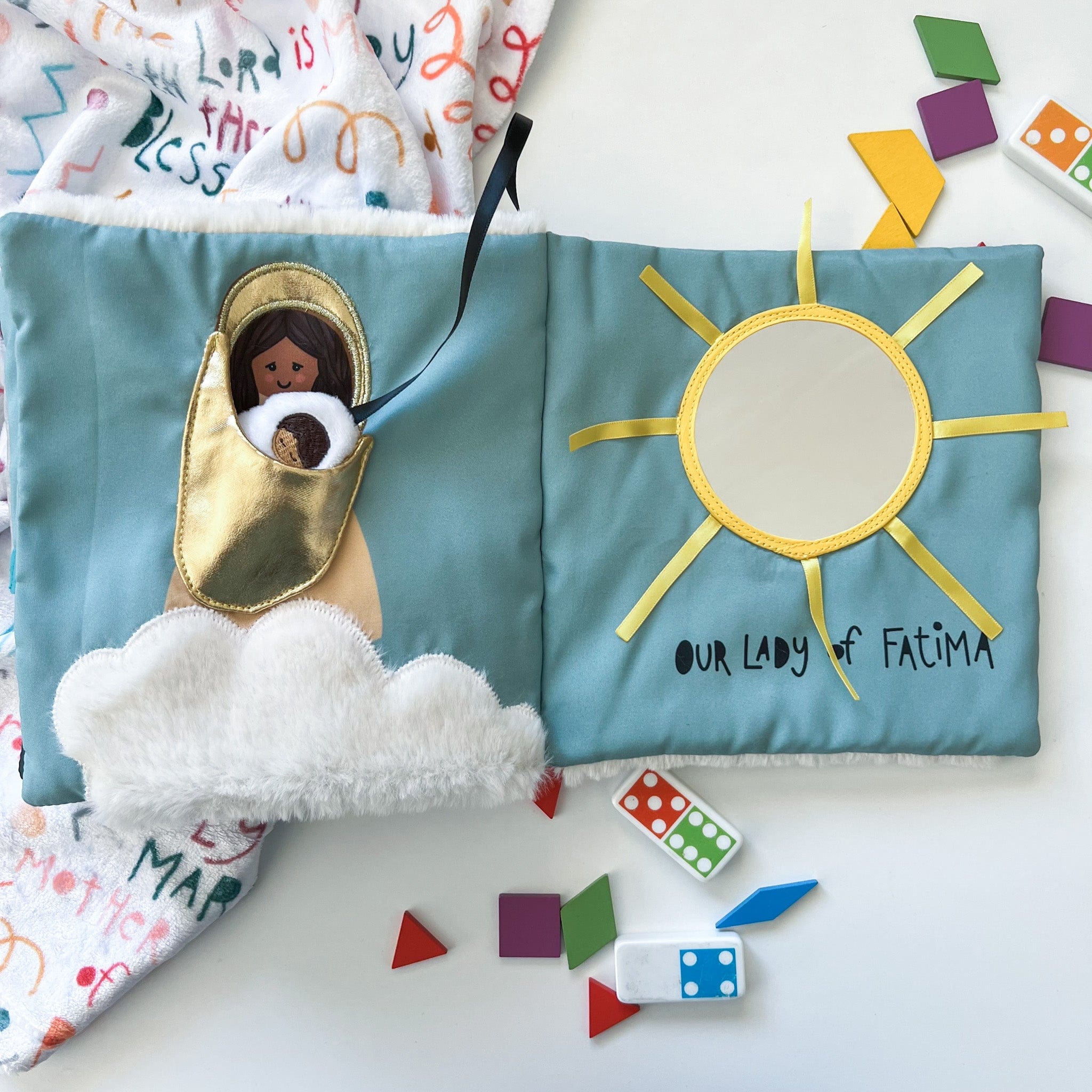Cloth book with image of Mary and the sun.