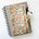 Notebook with pencil, floral pouch, and rosary.