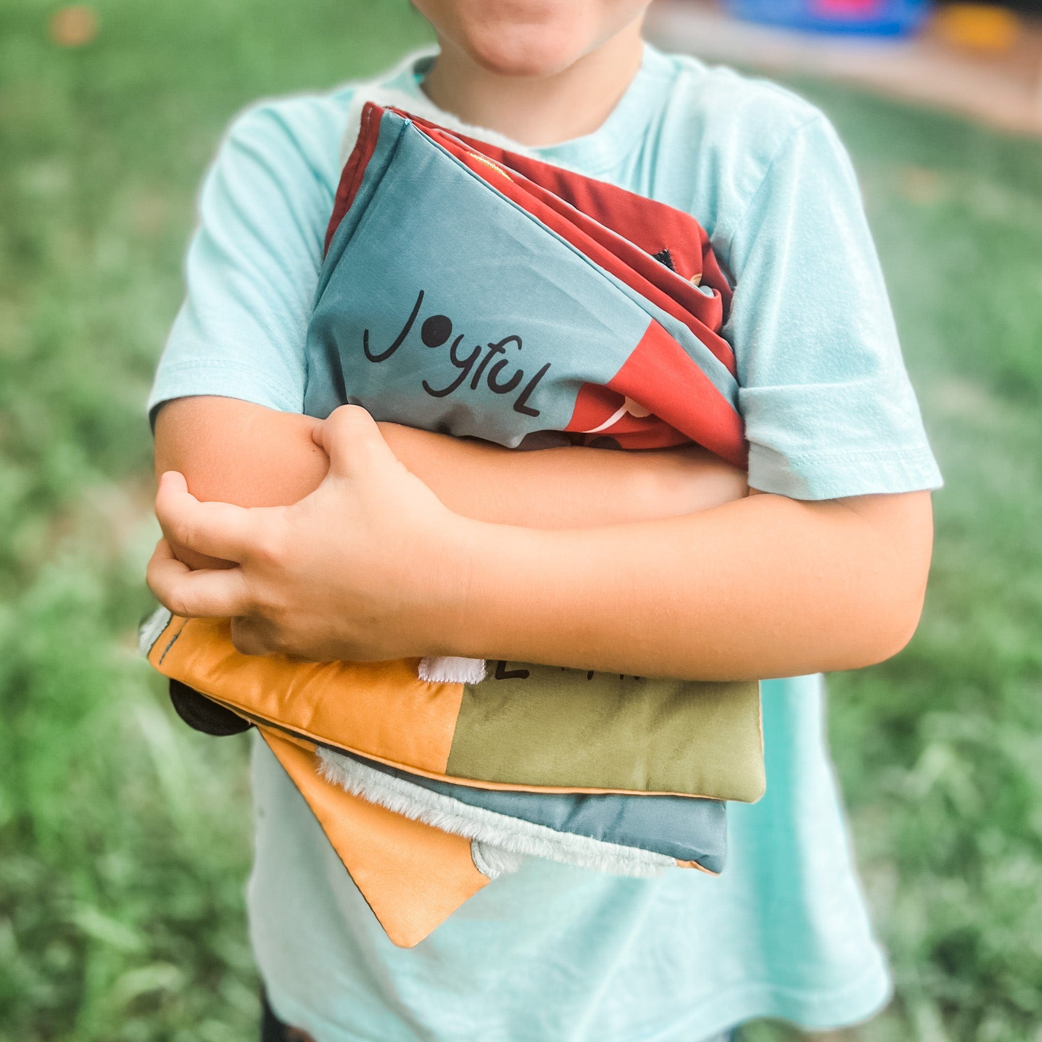 Child holding a colorful book.