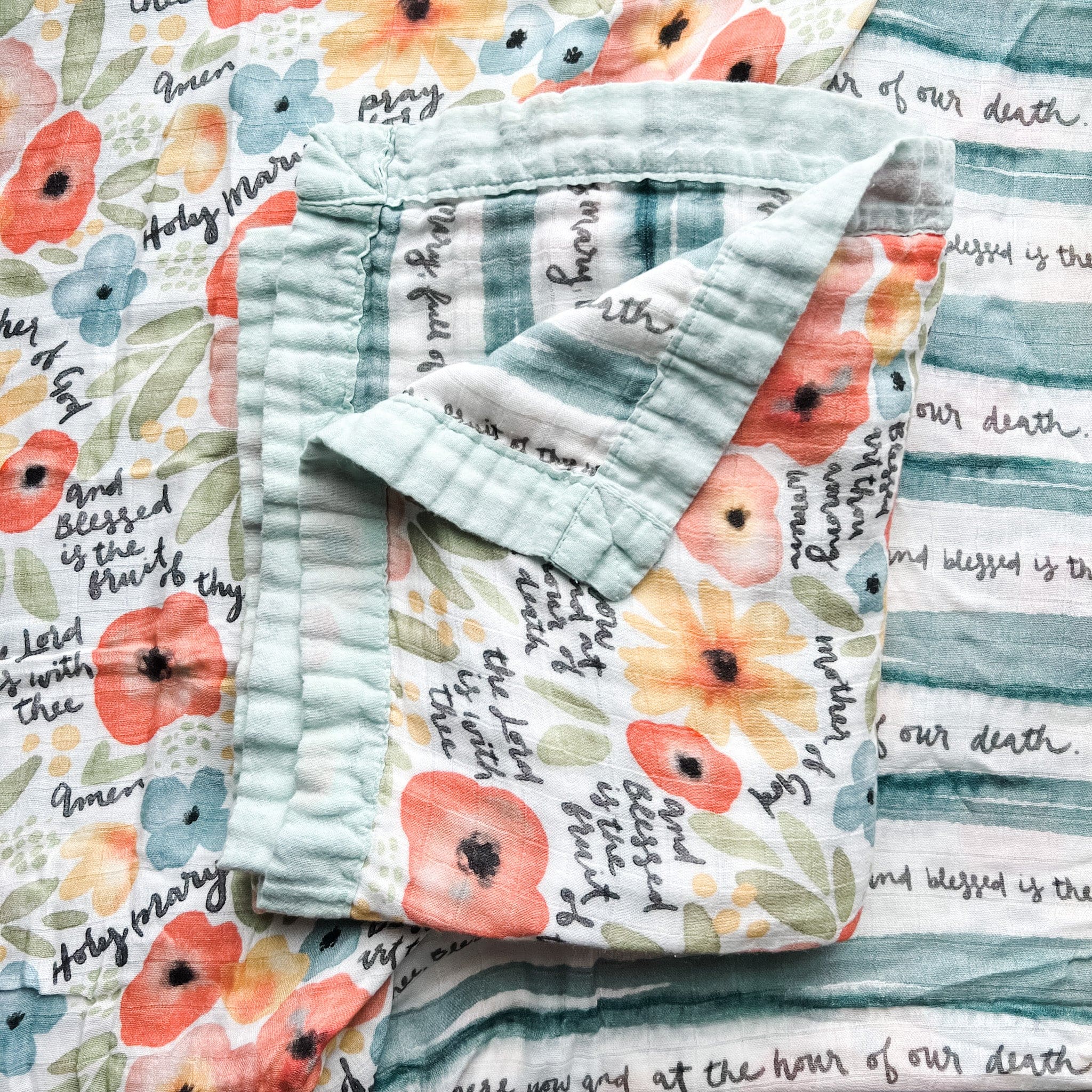 Folded floral quilt with text.