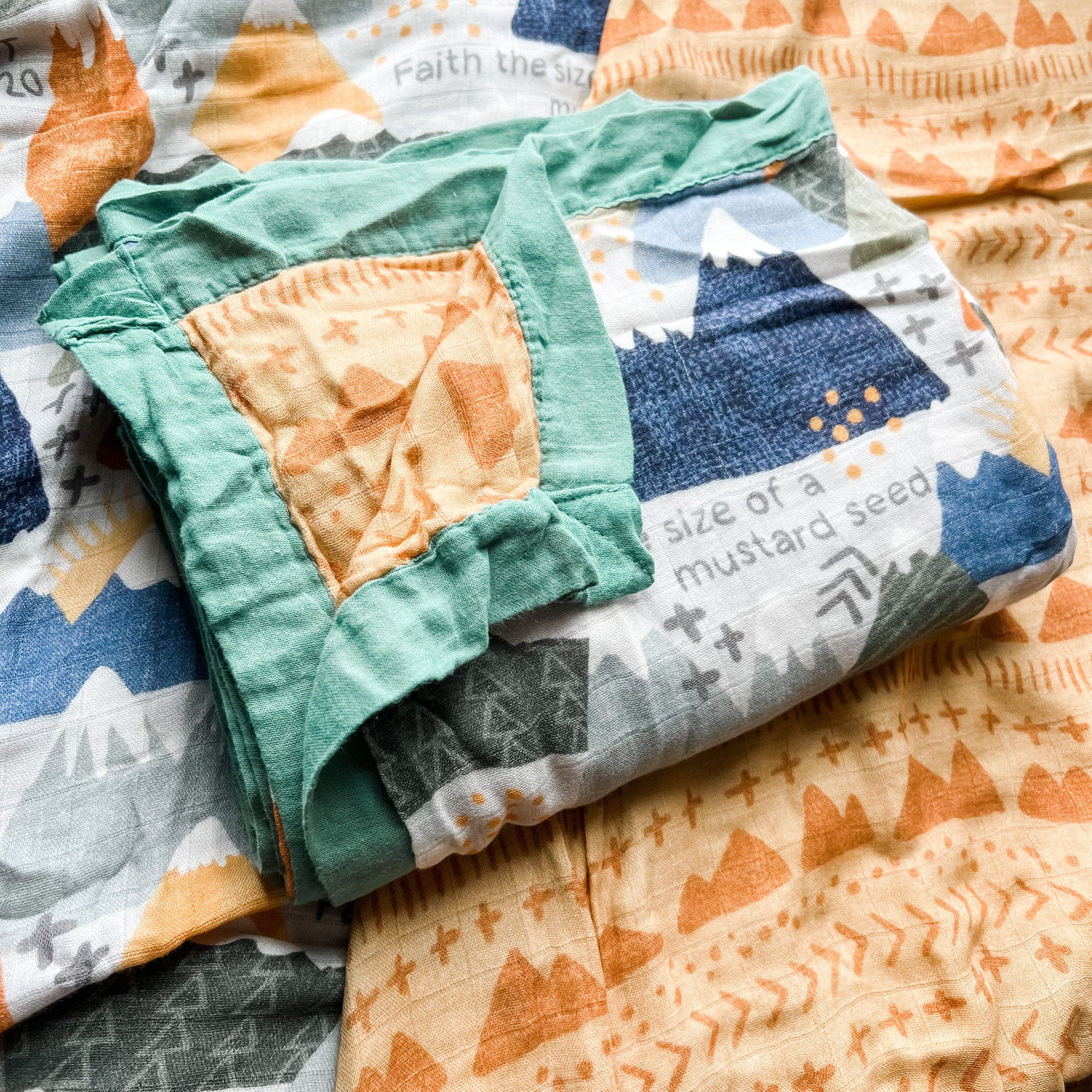 Baby blanket with mountain and mustard seed print.