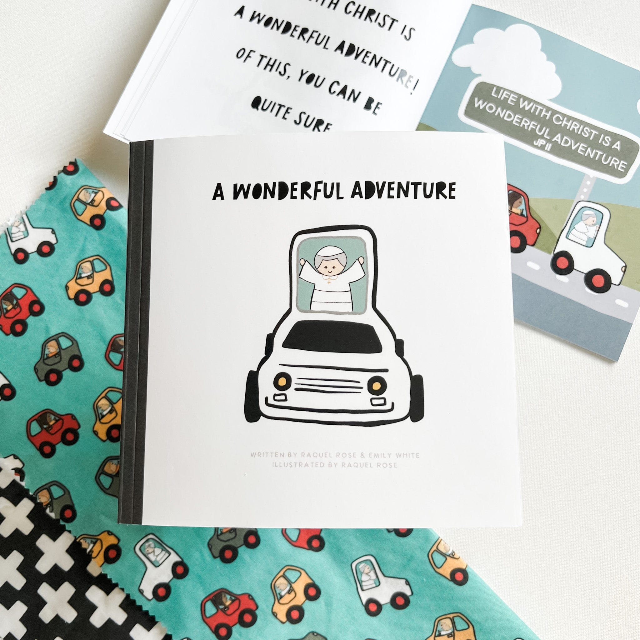 Book with car illustration, surrounded by car-patterned fabric and other books.