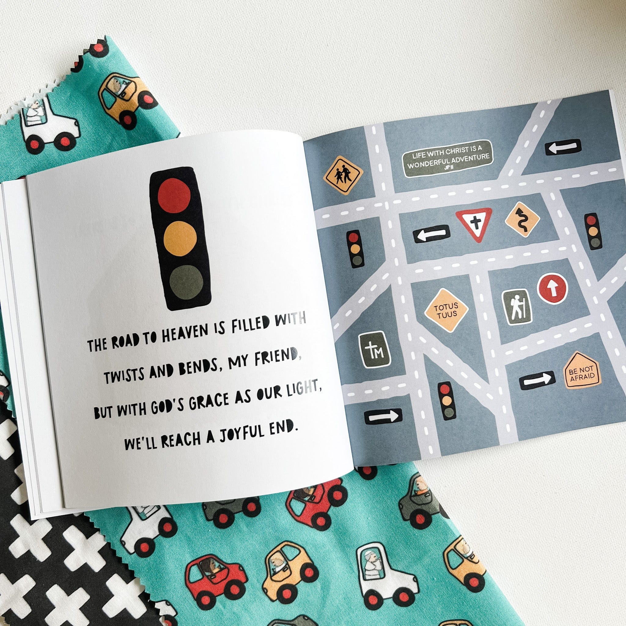 Open book with illustrations and text about a road.