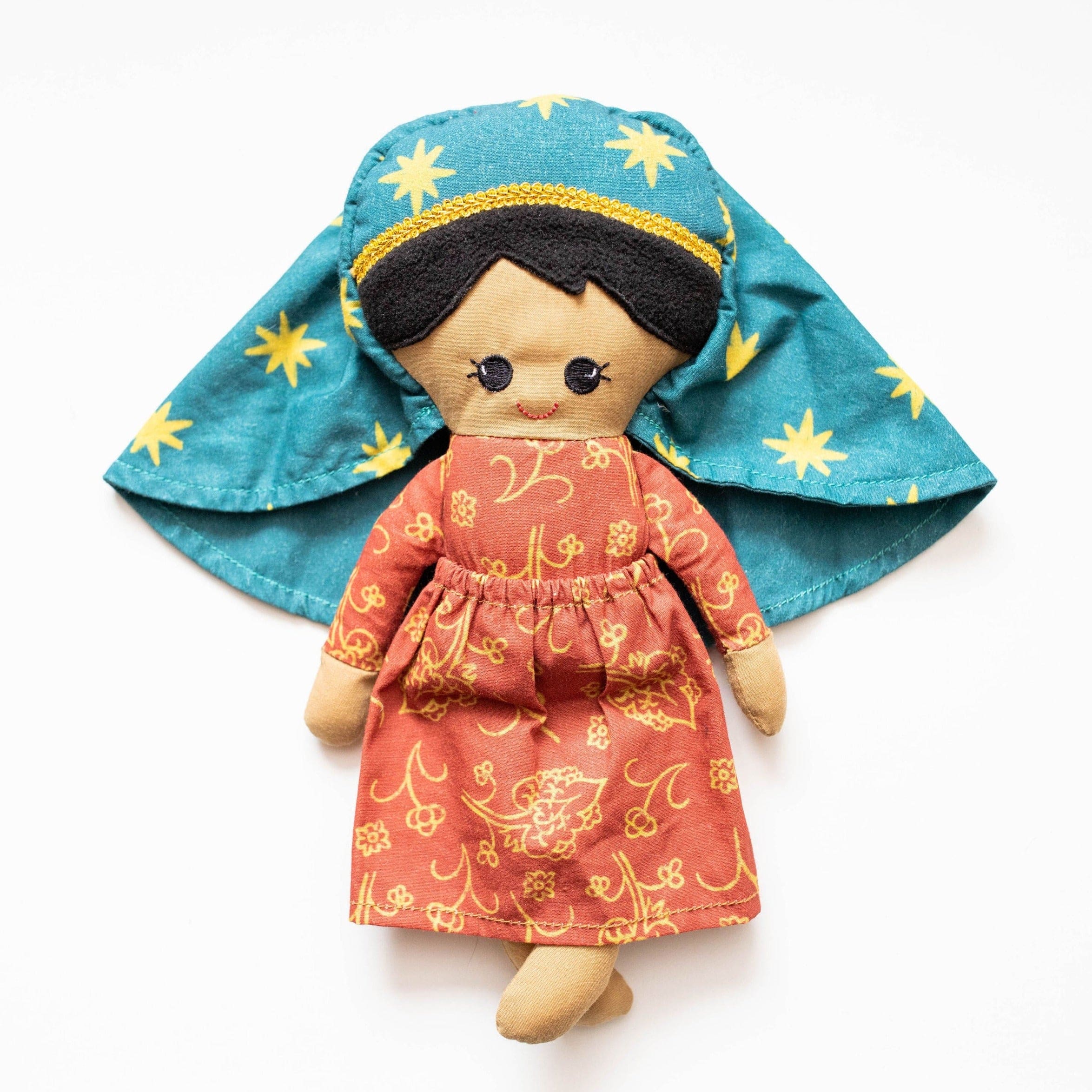 Handmade doll with teal headdress and floral dress