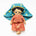 Handmade doll with teal headdress and floral dress