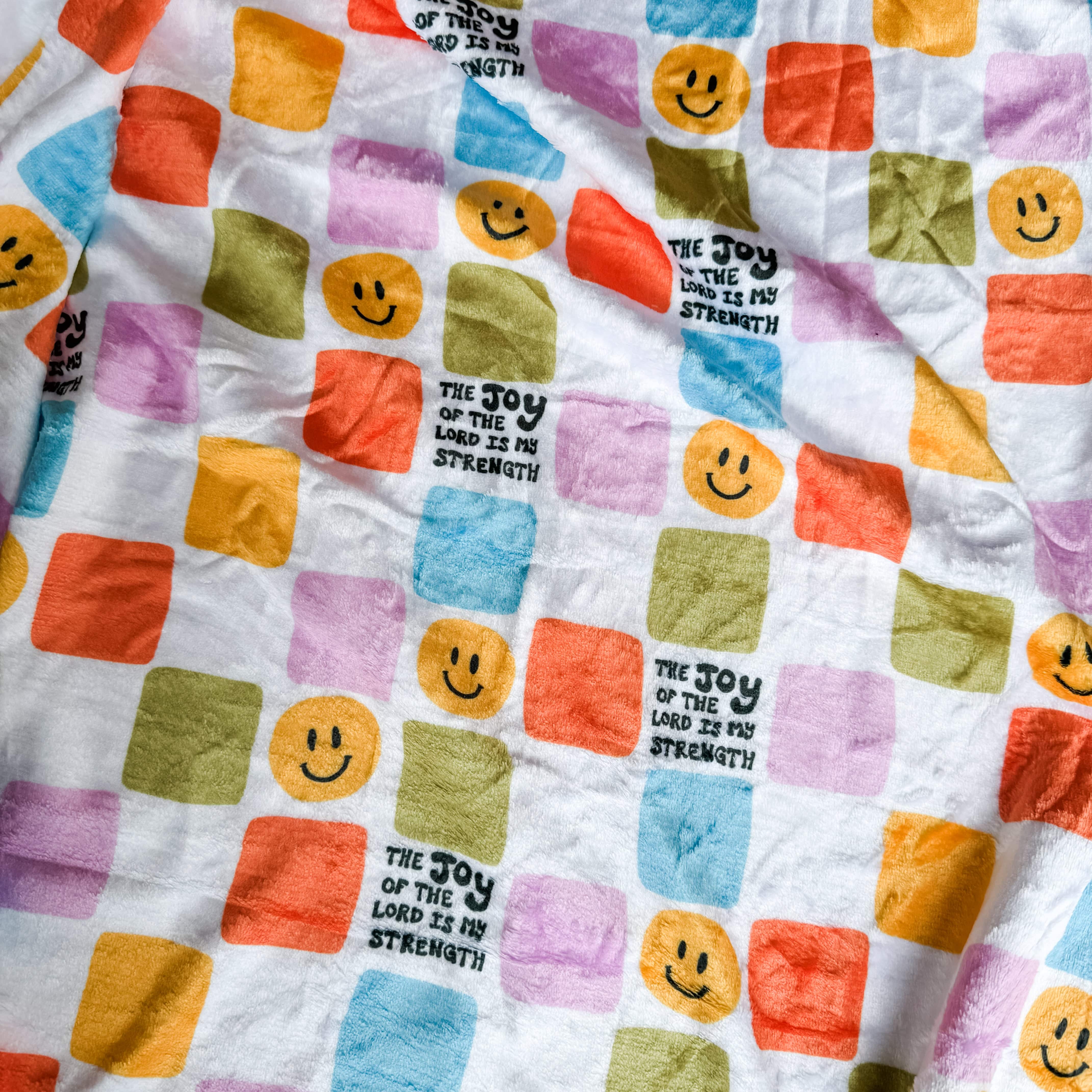 Joy of the Lord Minky blanket with smiley faces and scripture