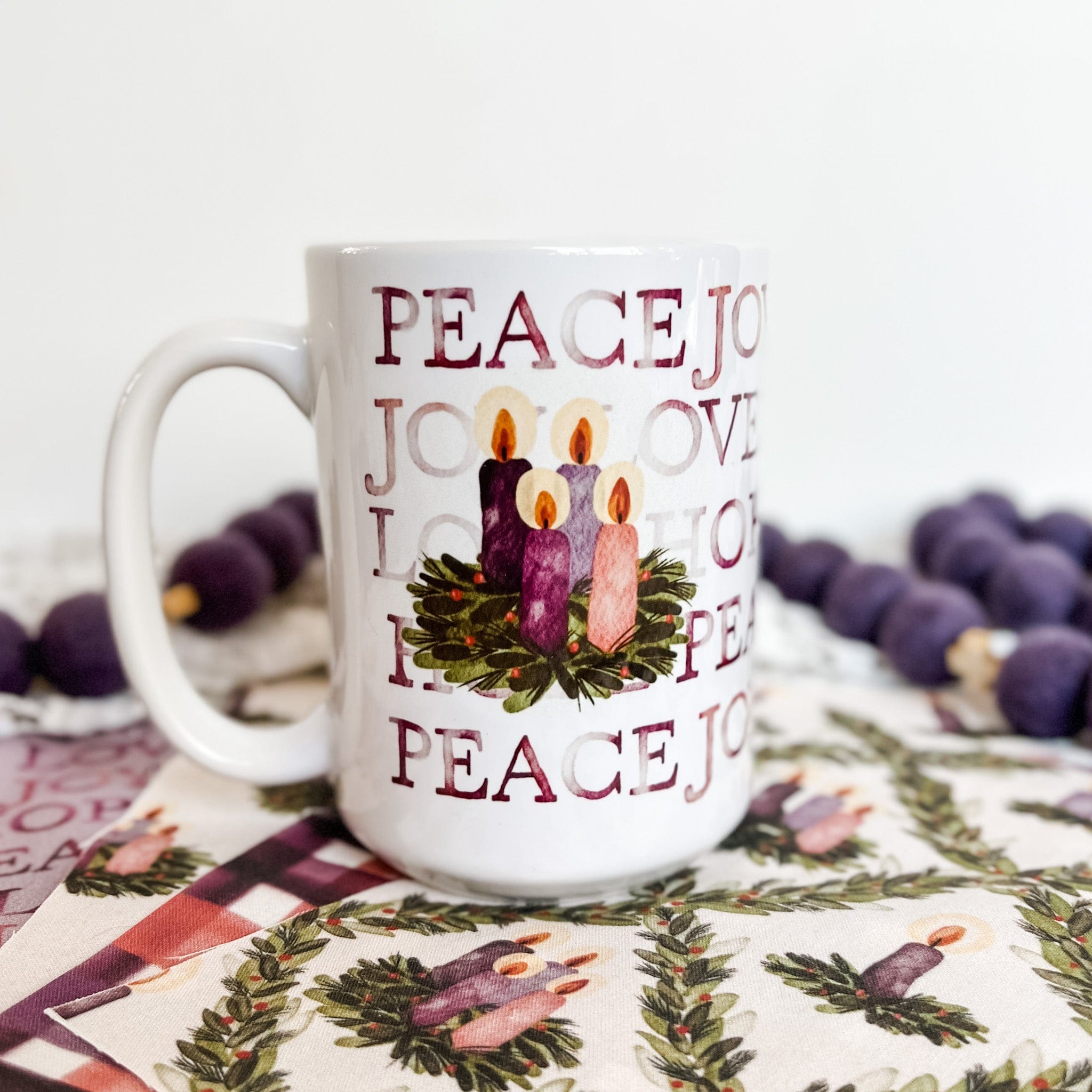 Advent mug with candles and the words Peace, Joy, Love, and Hope.