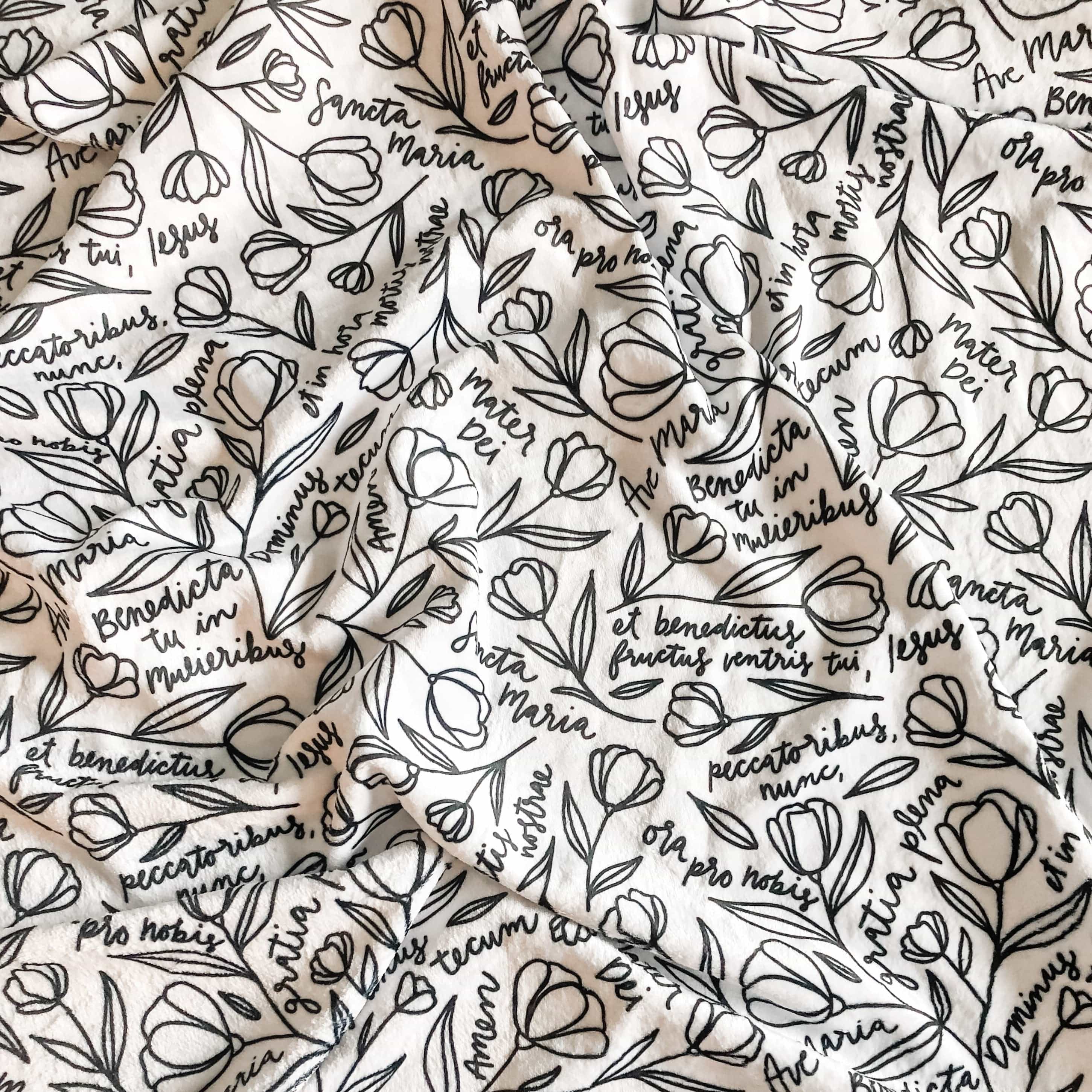 Black and white floral fabric with script writing.