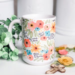 Floral mug with religious text.
