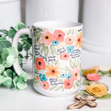 Floral mug with religious text.