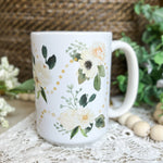 White mug with floral design.