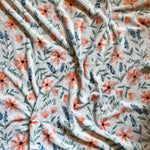 White blanket with floral pattern.