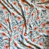 White blanket with floral pattern.