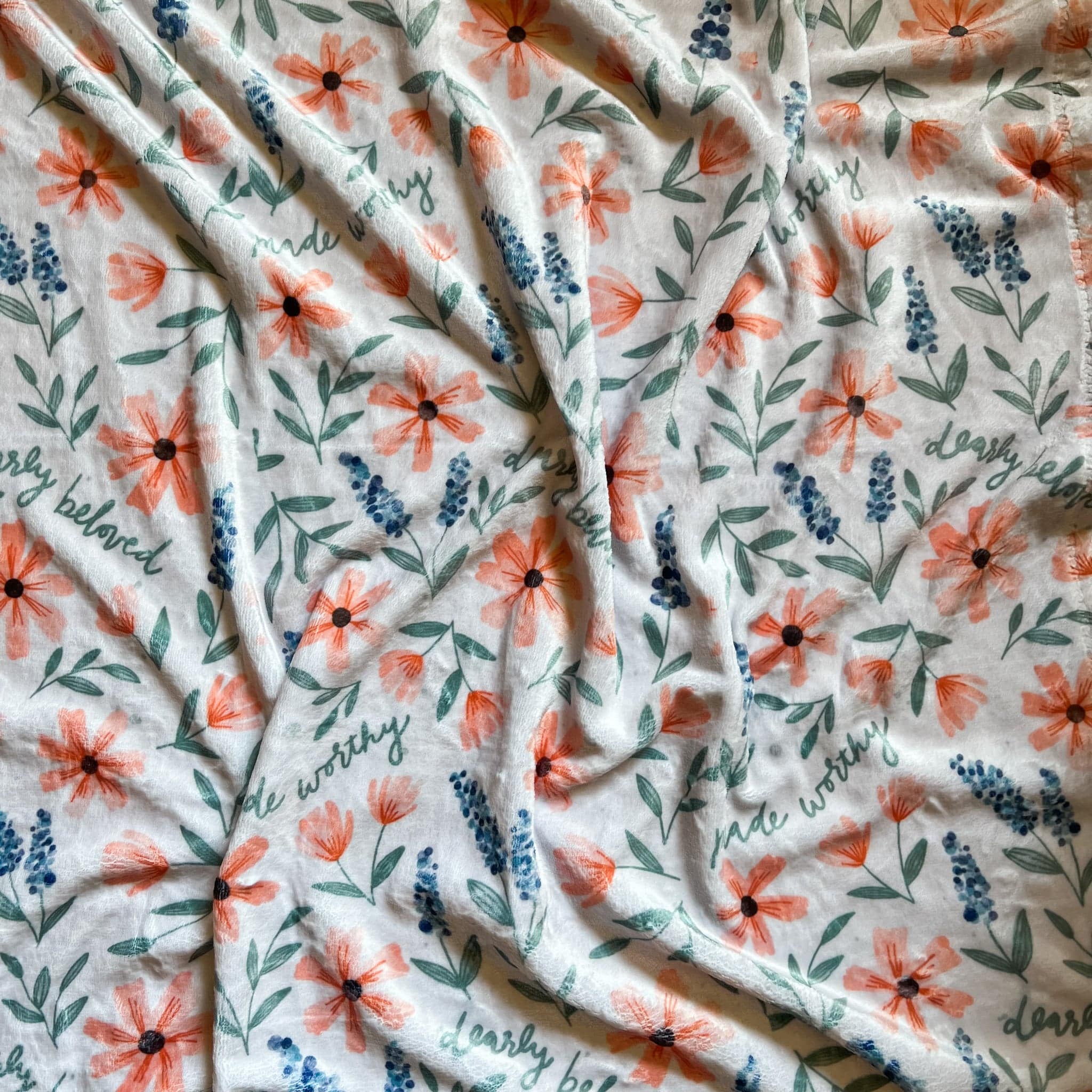White blanket with floral pattern.
