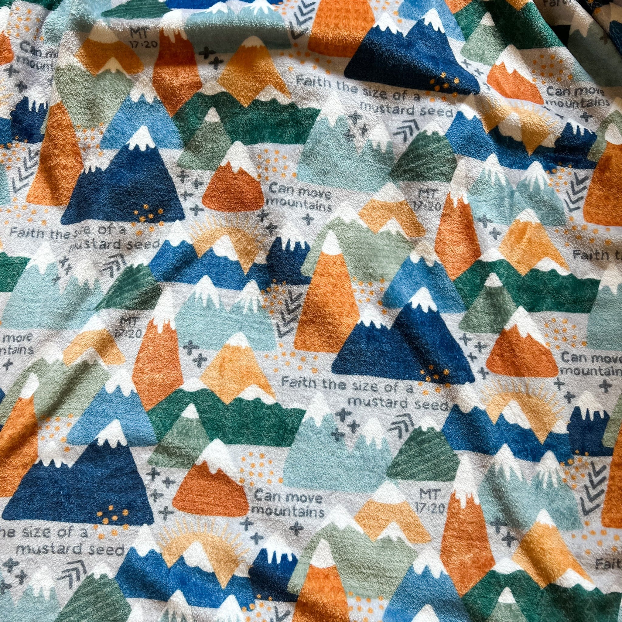 Fabric with a repeating mountain pattern.