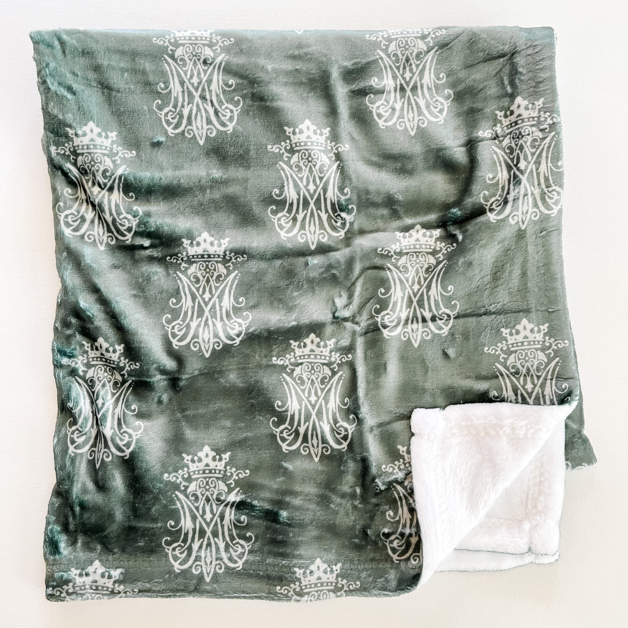 Gray blanket with white monogram pattern.