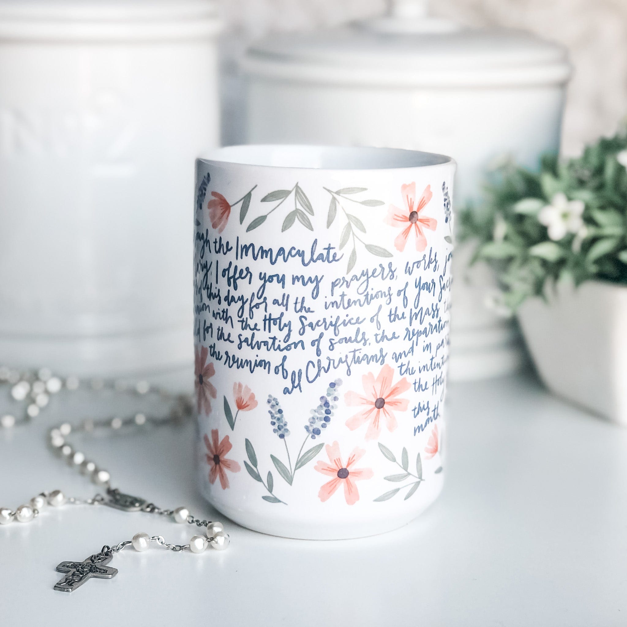 Floral mug with prayer text and rosary.