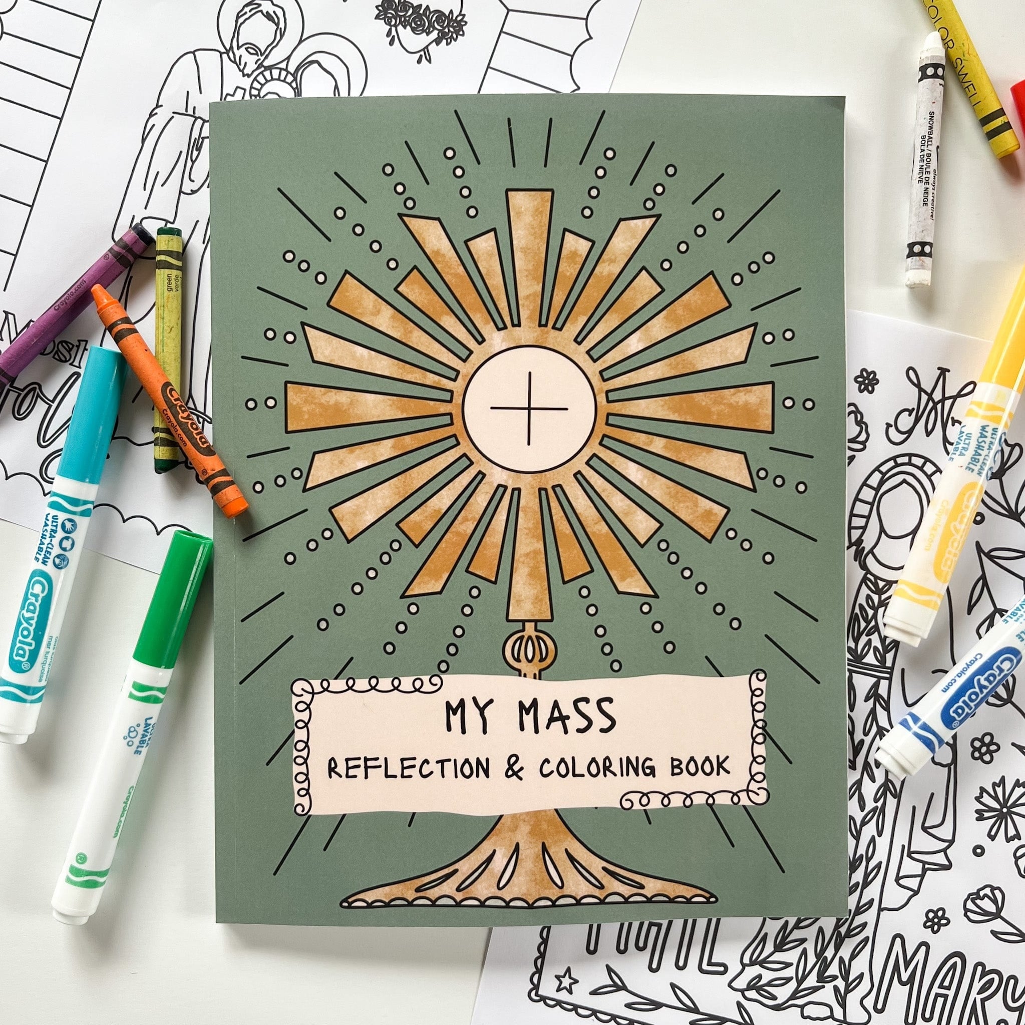 Coloring book with religious image and crayons.