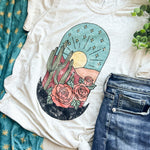 T-shirt with desert graphic and jeans.