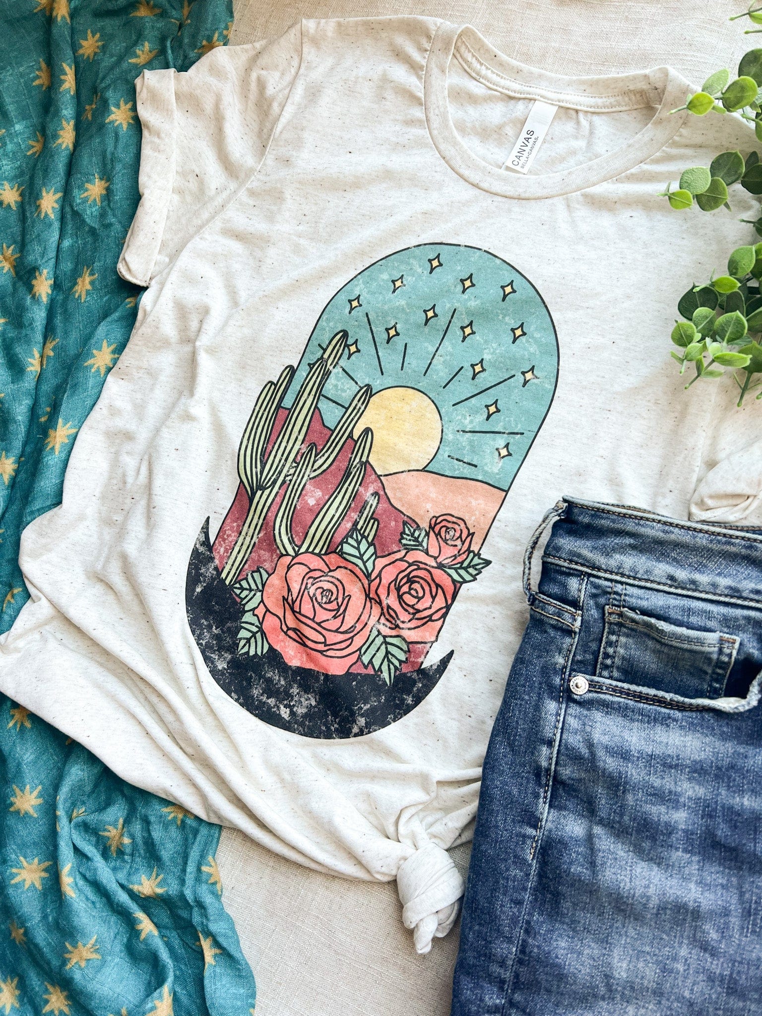 T-shirt with desert graphic and jeans.