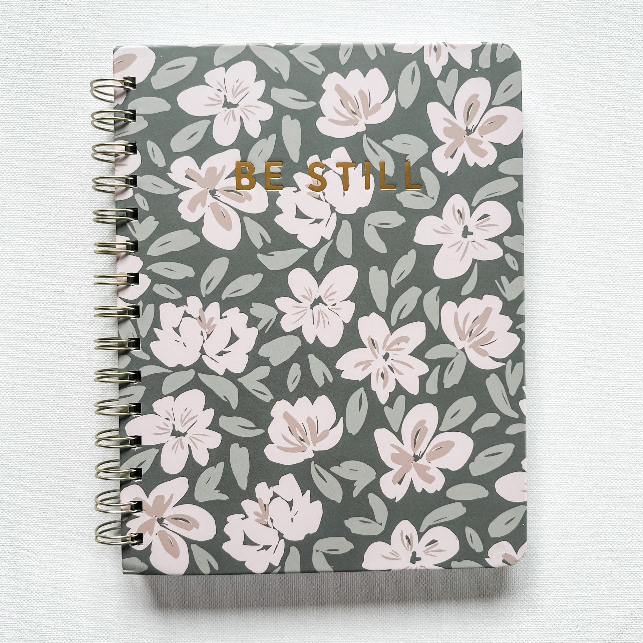 Spiral notebook with floral pattern and BE STILL.