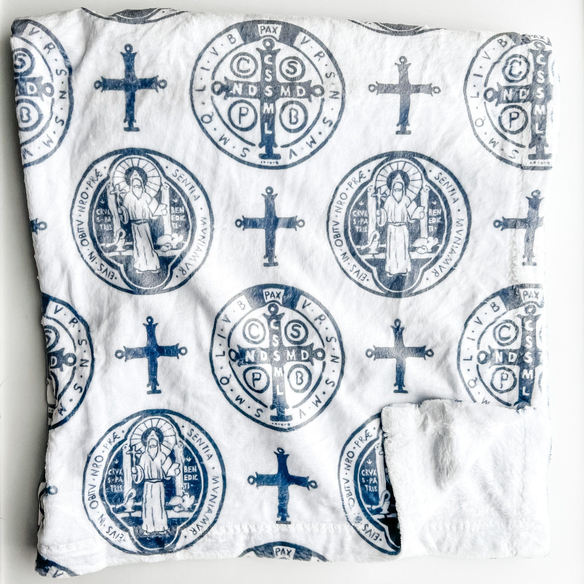 White cloth with blue religious symbols.