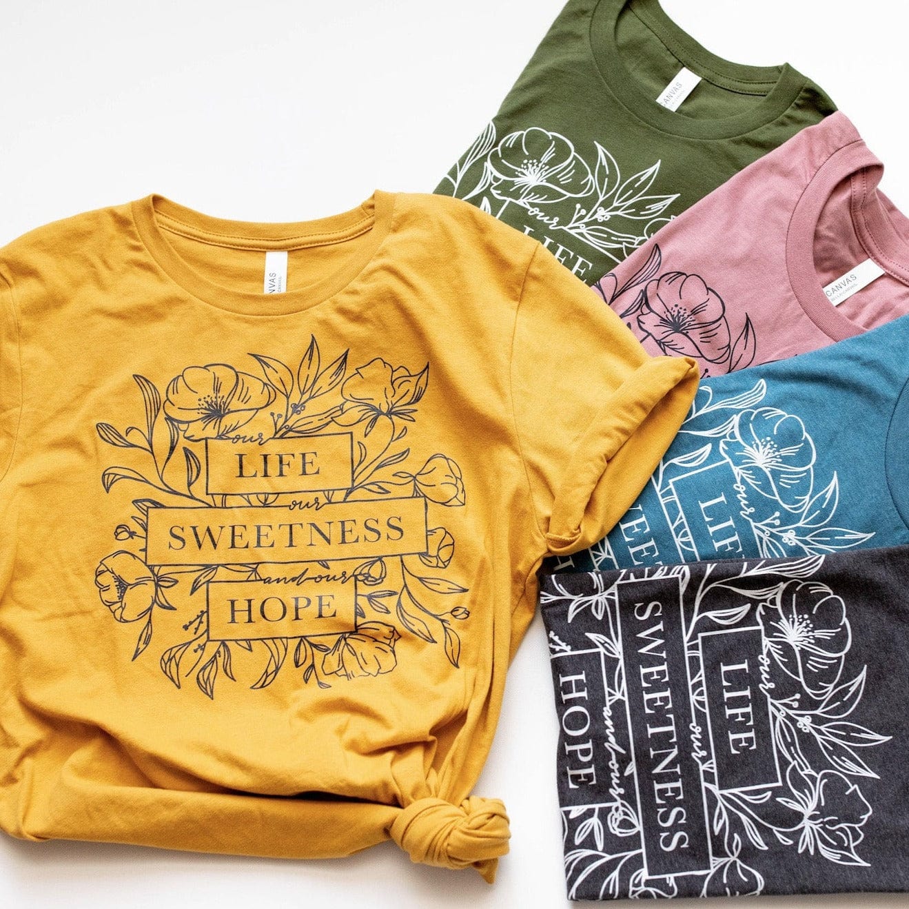 Lifesweetness shirts with floral design in various colors.