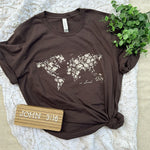 Solovedbrown t-shirt with floral world map design.