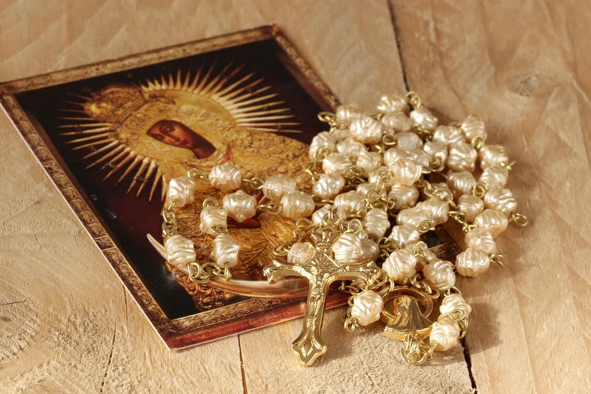 beautiful Rosary alongside a painting of Mary to show what a Rosary is