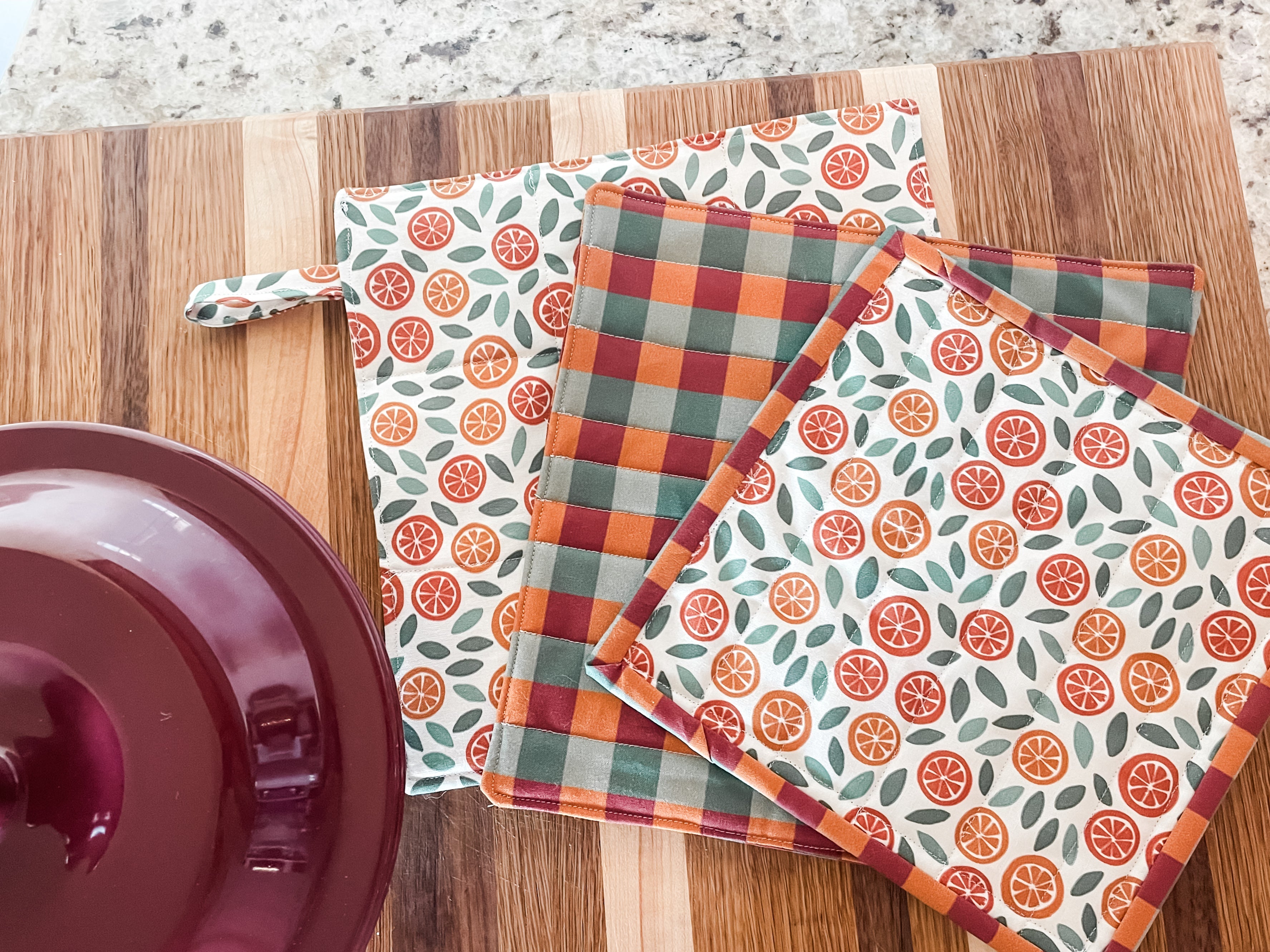 DIY Catholic potholders made with St. Nick-inspired fabric from The Little Rose Shop displayed on kitchen counter