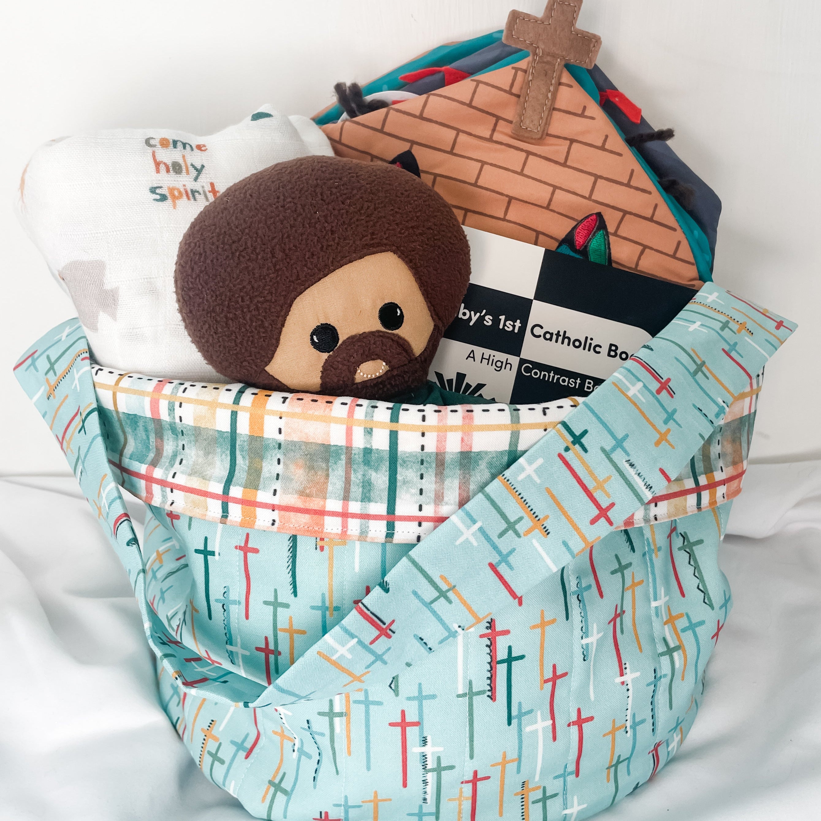 Catholic fabric basket displayed in a prayer corner with devotional items
