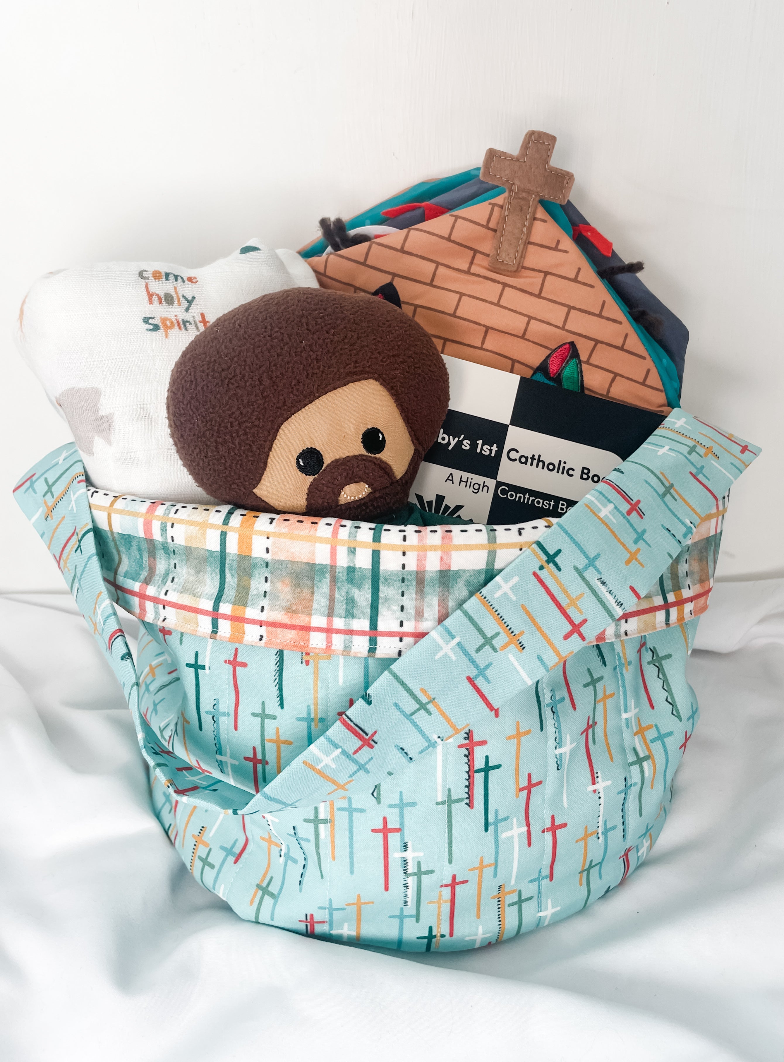 Catholic fabric basket displayed in a prayer corner with devotional items