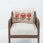 Chair with a decorative pillow featuring hearts on a white background
