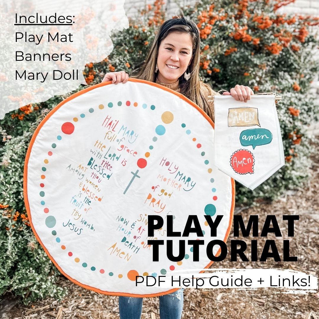 Woman holds up a play mat with a rosary design