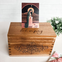 Wooden box with Let us pray and religious card.