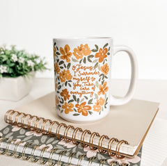 Surrender mug with floral design and inspirational quote.