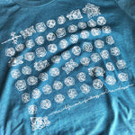 Blue t-shirt with white rose pattern.