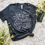 Gray t-shirt with floral design and text.