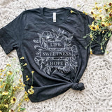 Gray t-shirt with floral design and text.