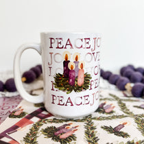 Advent mug with candles and the words Peace, Joy, Love, and Hope.