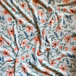 White blanket with floral pattern.