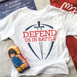 White t-shirt with Defend Us In Battle graphic.