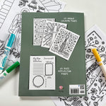 Coloring book with pages, markers, and floral drawings.