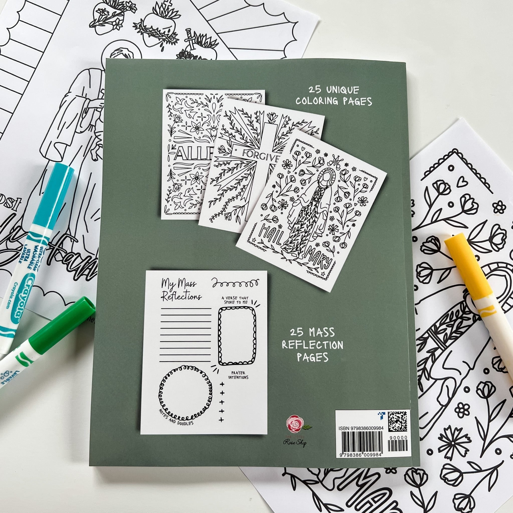 Coloring book with pages, markers, and floral drawings.