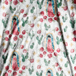 Fabric with floral, cactus, and Virgin Mary print.