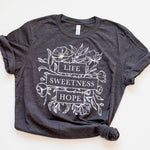 Gray t-shirt with floral design and text.